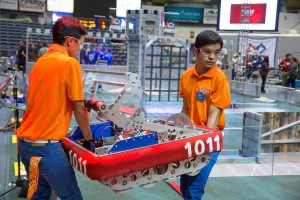 Students carrying robot