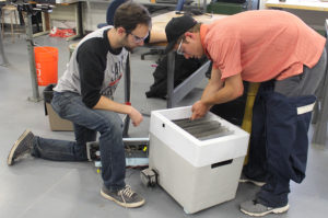 two men build an atmospheric water generator
