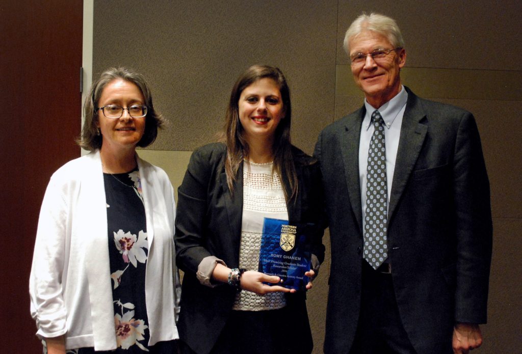 Romy Ghanem holds her award next to Diane Stearns, left, and Vice President for Research Bill Grabe
