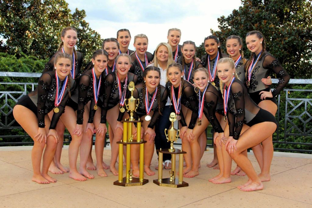 NAU Dance team poses with trophies