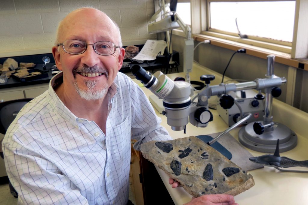 D.K.Elliott in lab with fossil heterostracans