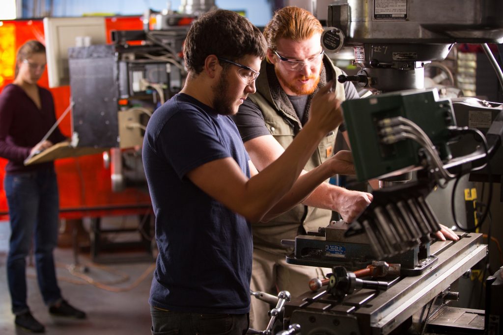 Engineering students run machine