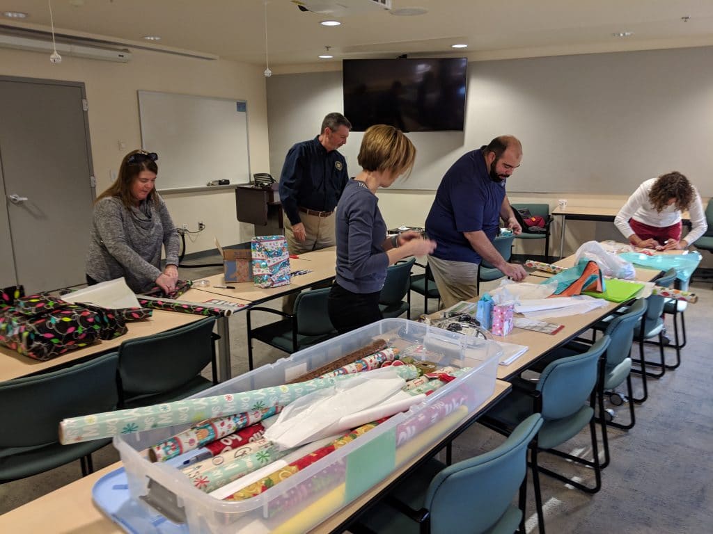 volunteers wrapping gifts