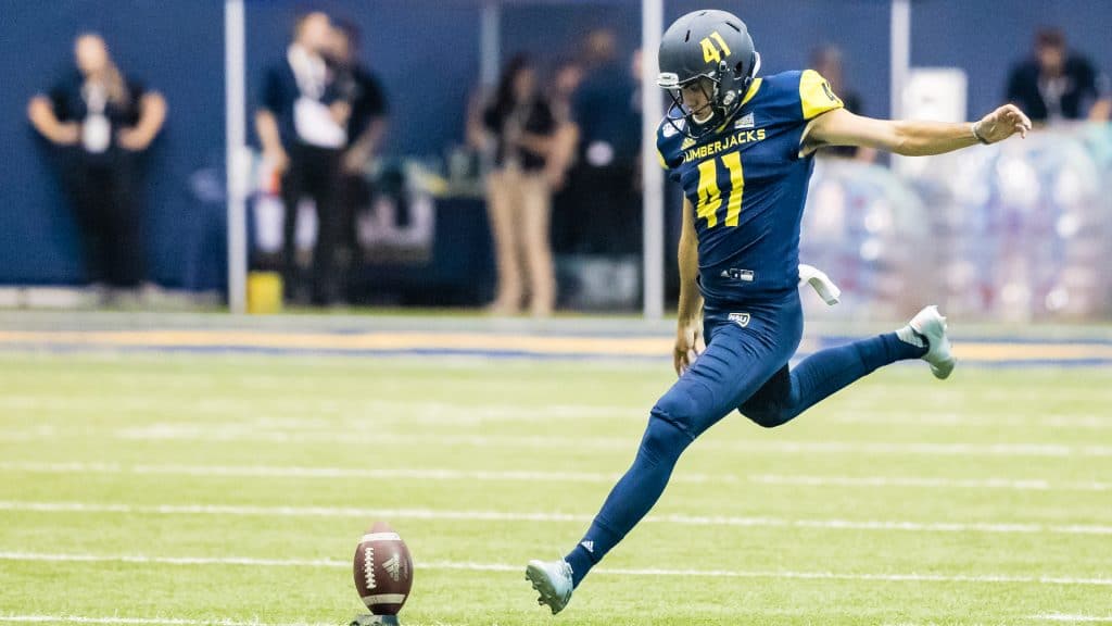 Luis Aguilar kicks a football off of the tee