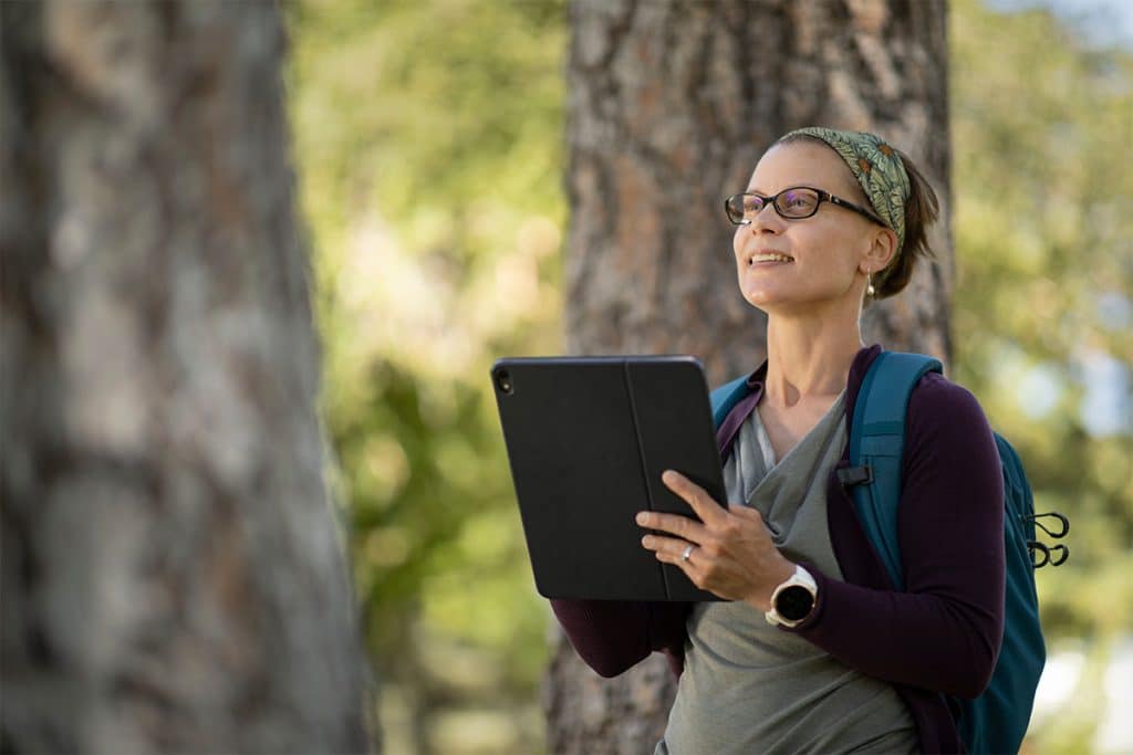 Deborah Huntzinger does research in the forest.