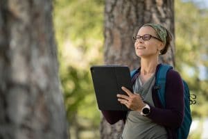 Deborah Huntzinger does research in the forest.