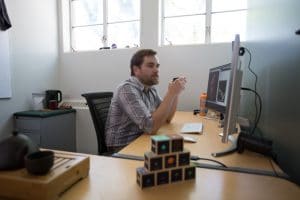 Ty Robinson sits at his desk.
