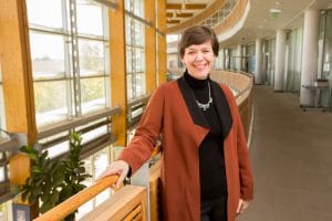Julie Baldwin stands in building