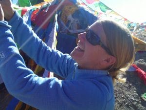 Julie Mueller hangs prayer flags in Nepal
