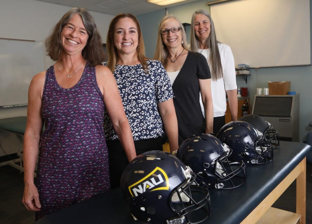 Four researchers stand together