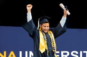 Student walking across the stage at commencement