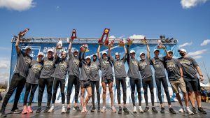 Men's cross country team with trophies
