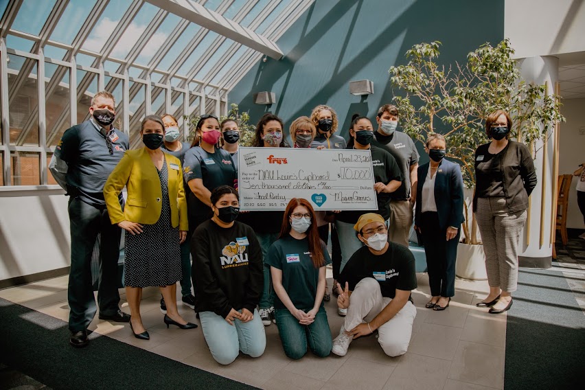 Louie's Cupboard and Fry's representatives pose with check