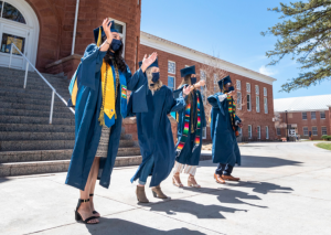 Graduates celebrating in front of old main
