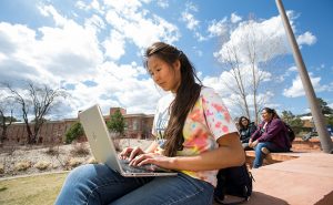 Native American woman works on her computer