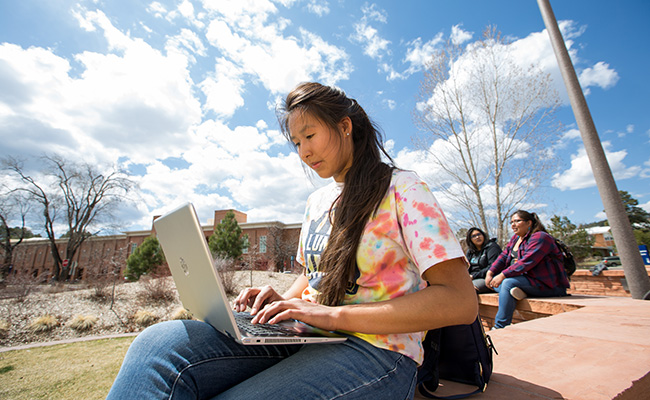 Native American woman works on her computer
