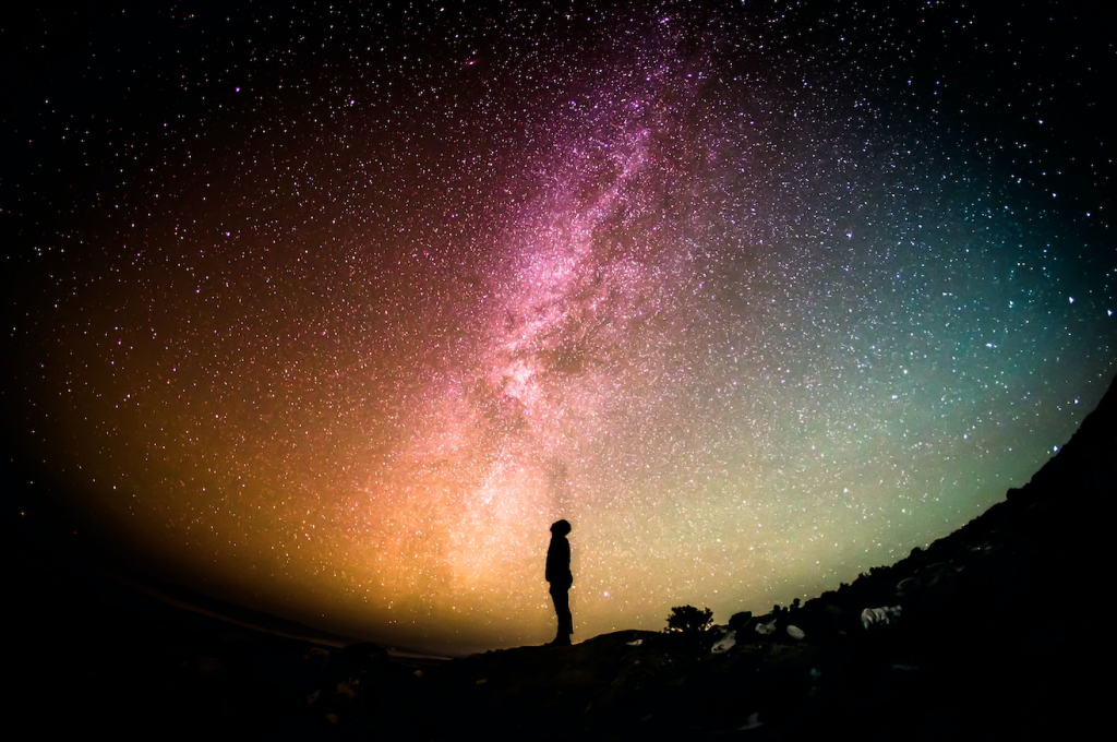 Person looks up at milky way