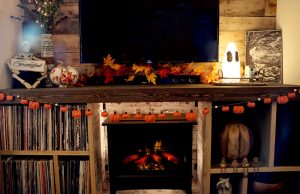 Pumpkin garland hangs on TV stand