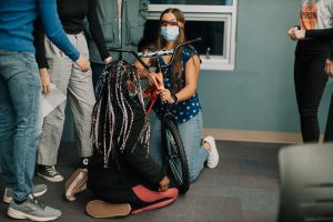 Blindfolded student working on a bike