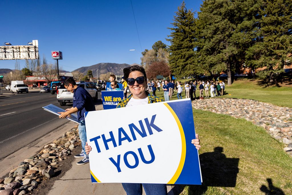 Lumberjack holding thank-you sign