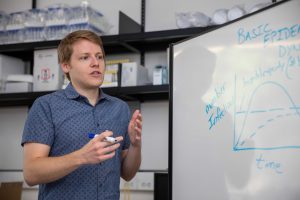 Joseph Mihaljevic with a white board and marker