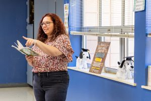 A teacher stands at the front of a classroom