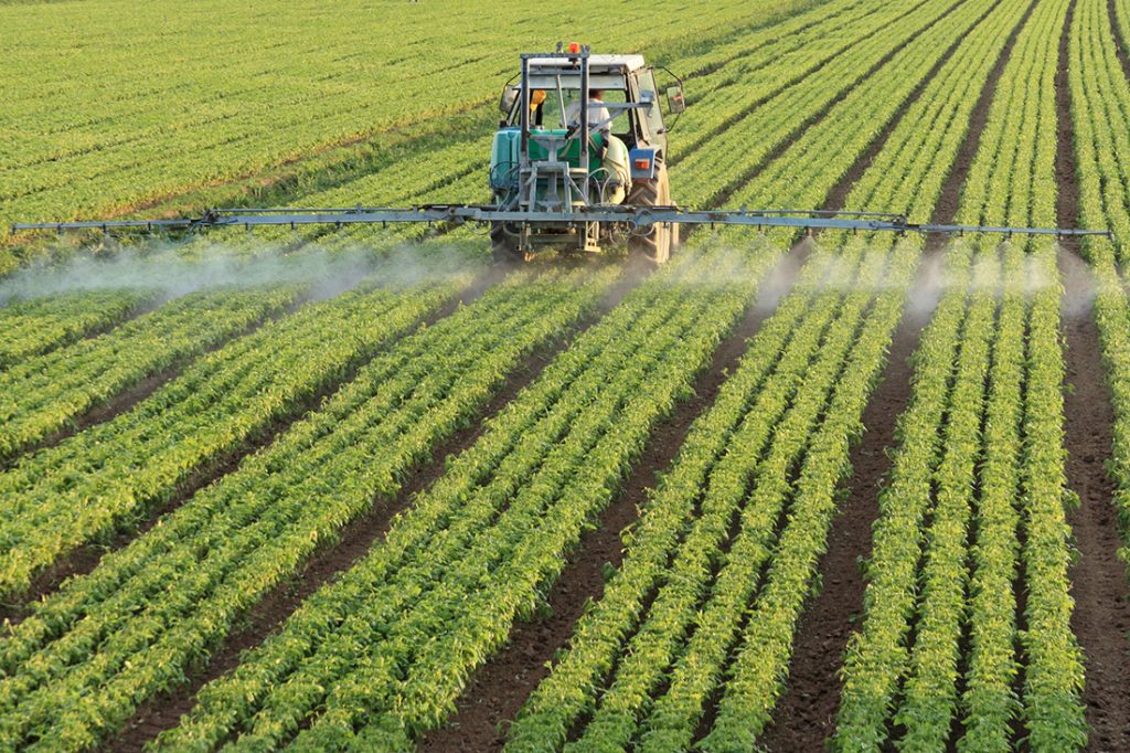 Farmer fertilizing fields