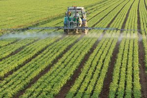 Farmer fertilizing fields