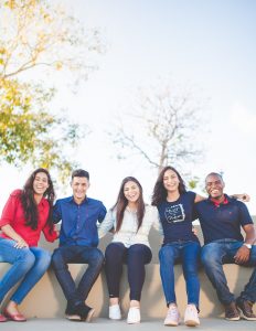 Group of students sit outside