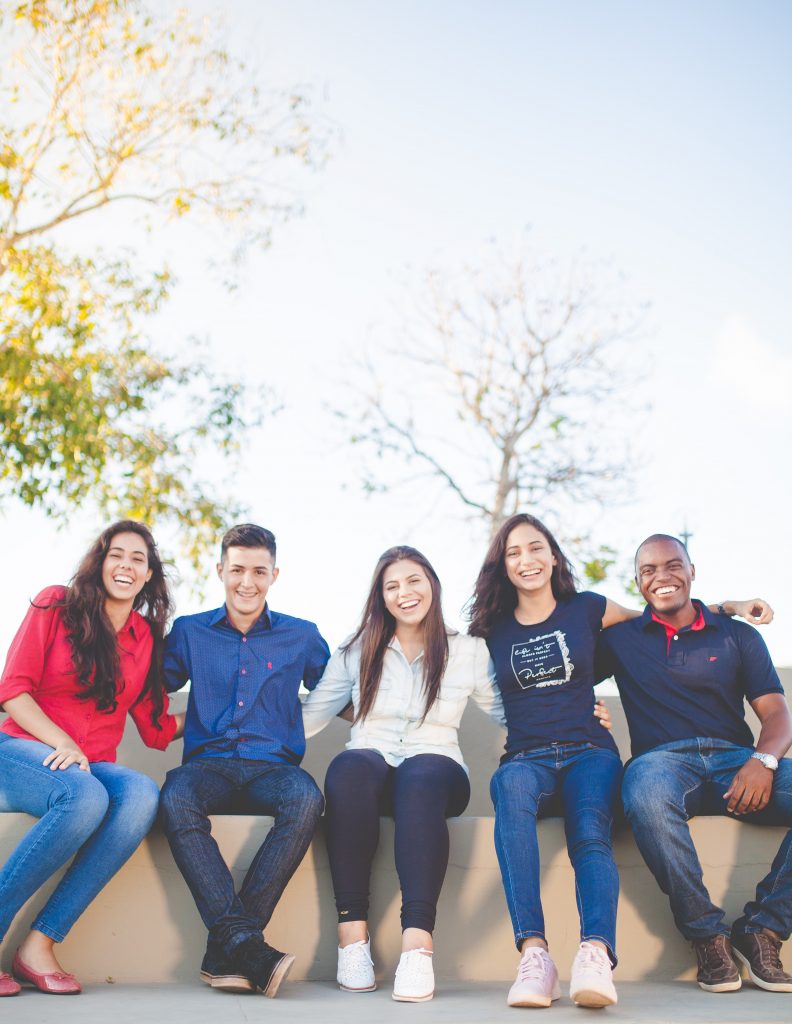 Group of students sit outside