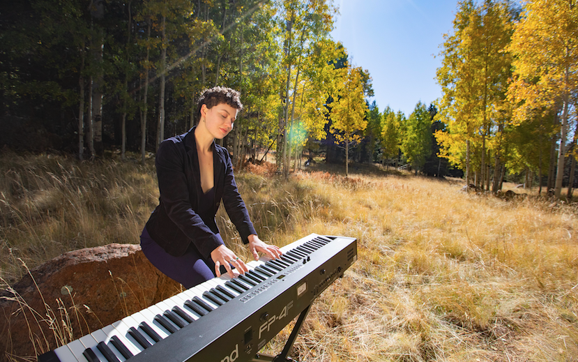 Student plays keyboard outside