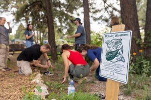 Monach Waystation sign with students in the background