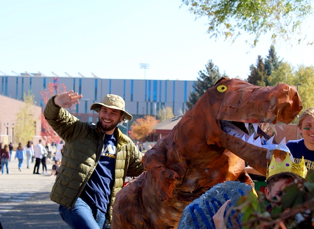 Brendan Trachsel with a person in a T-rex costume