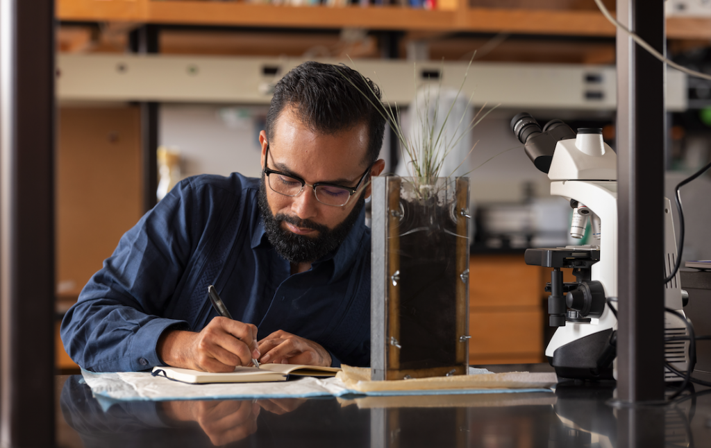 Javier Ceja-Navarro writes in journal in lab