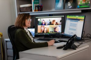 Ronda Jenson working with two computer screens