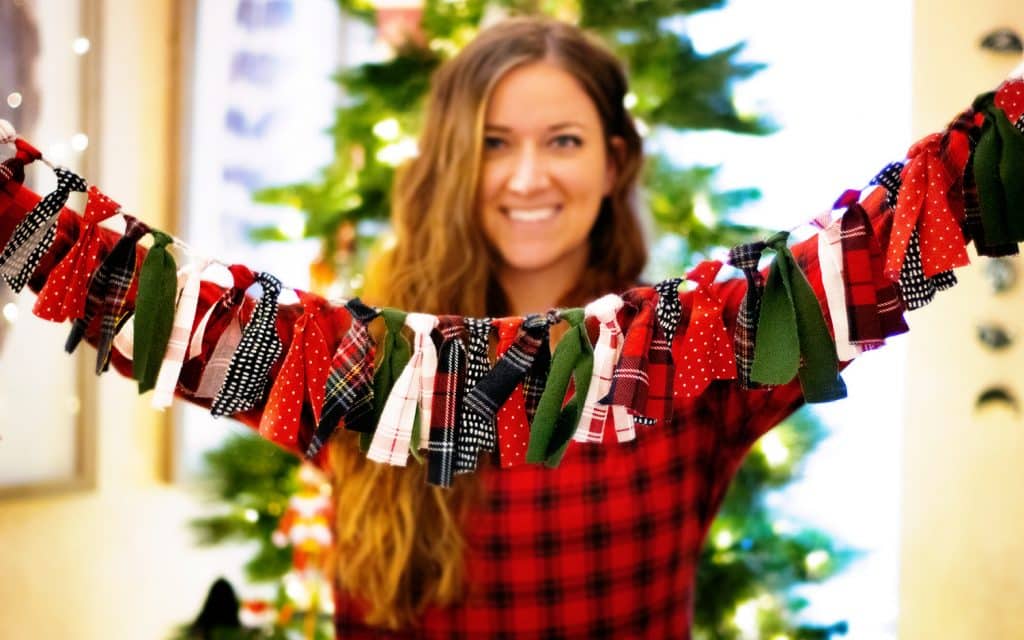 Woman holds up holiday garland