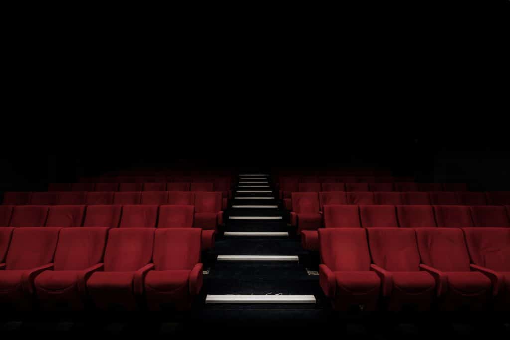 Cinema with red seats in the dark/black background