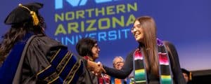 Students in grad robes at Hispanic convocation