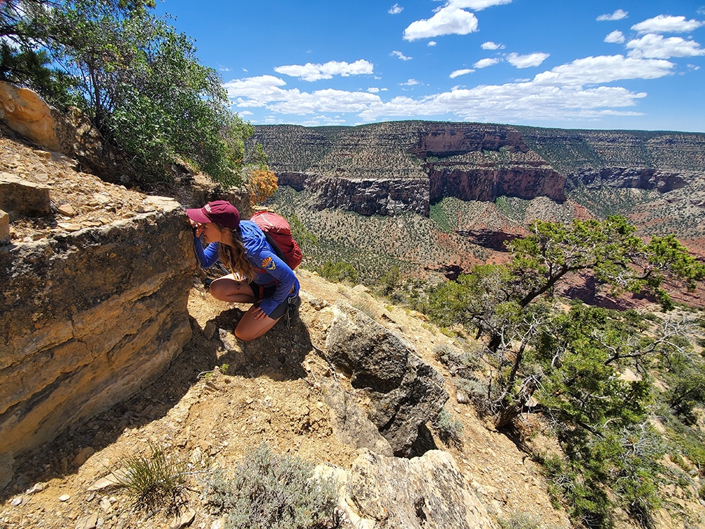 Anne Miller using a hand lens on a sunny day in the Grand Canyon