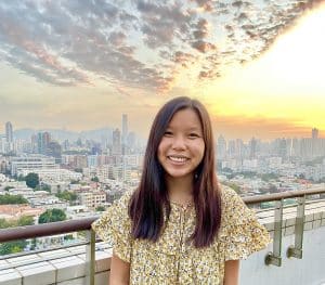 Cate Cameron in front of a sunset in Hong Kong
