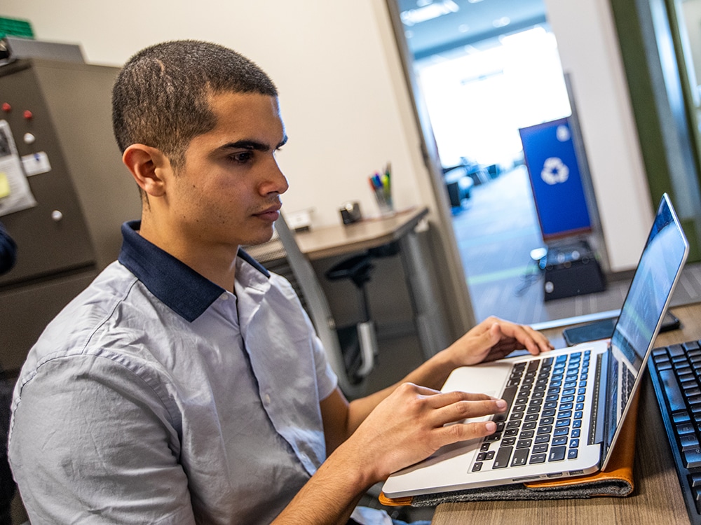 NAU student types on laptop