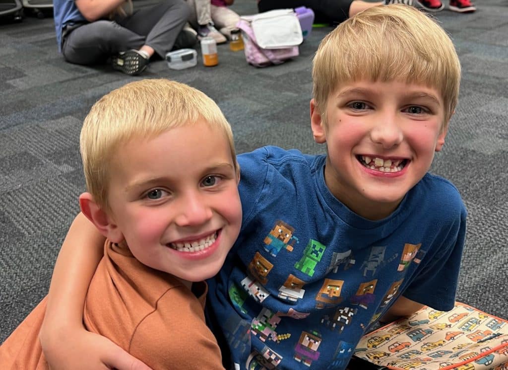Two boys hug