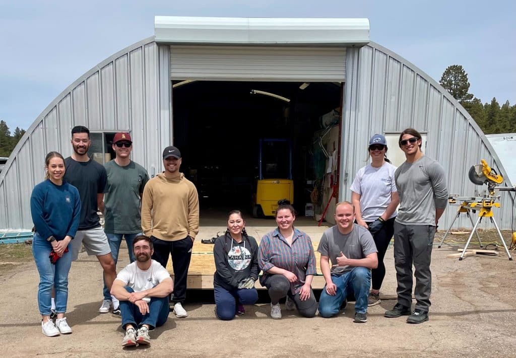 PT students pose in front of a garage after doing volunteer building work.
