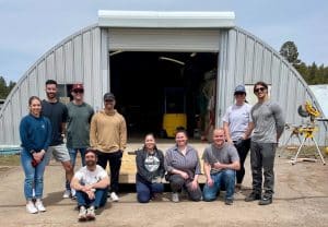PT students pose in front of a garage after doing volunteer building work.
