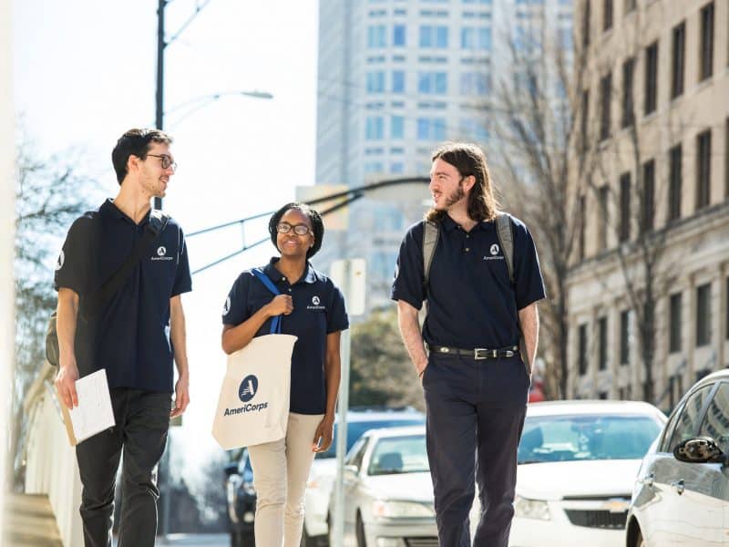 Americorps volunteers walking down the street