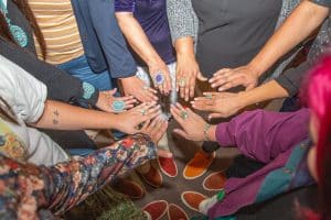 Hands in a circle showing turquoise jewelry at Rock Your Mocs