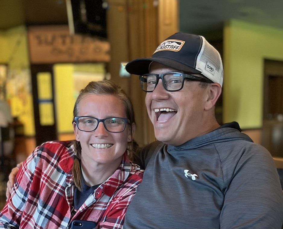 Gabrielle Garcia and her husband smile at the camera.