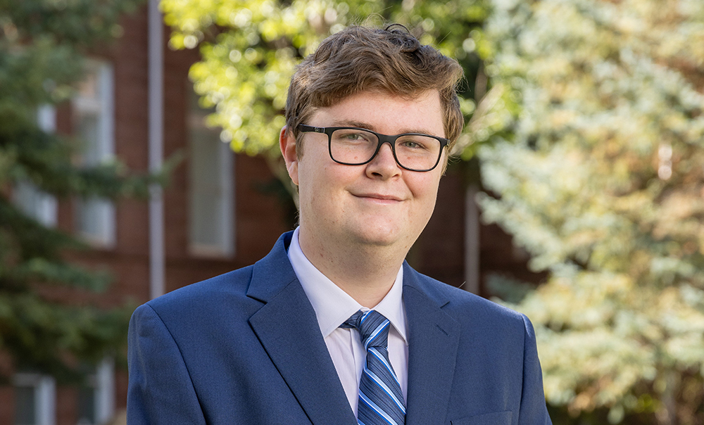 Headshot of Jacob Kane in front of Old Main