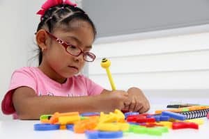 Latina girl writes on paper