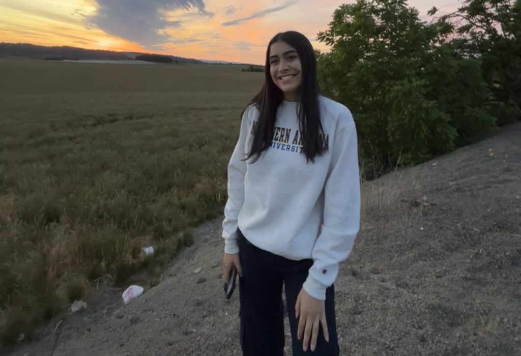 Cecilia Perez posing on top of a rock at sunset
